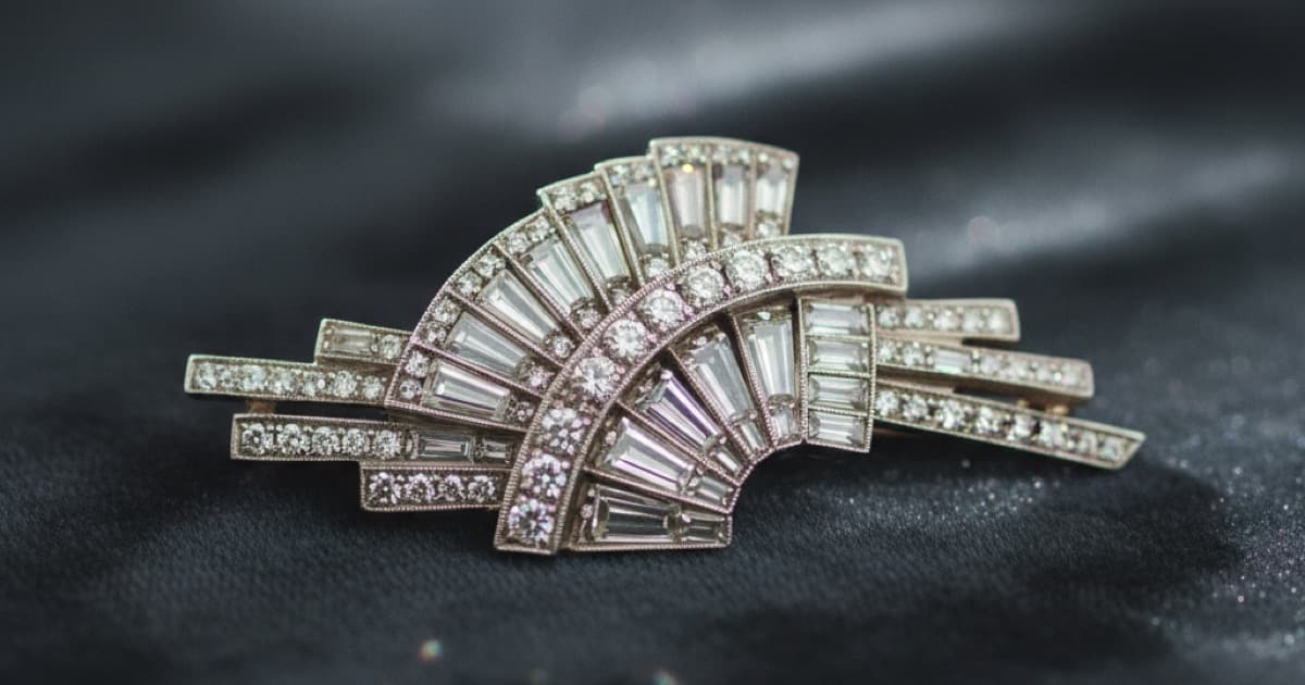 Art Deco diamond brooch with geometric patterns on dark velvet