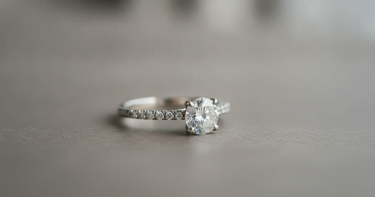 Close-up of a white gold ring showing yellowing on the underside where rhodium plating has worn off