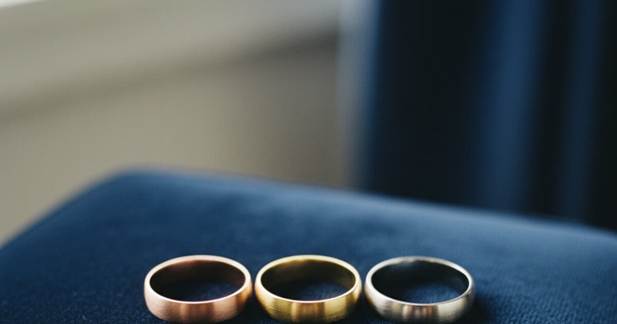 Three gold rings side by side showing rose gold, yellow gold, and white gold color differences